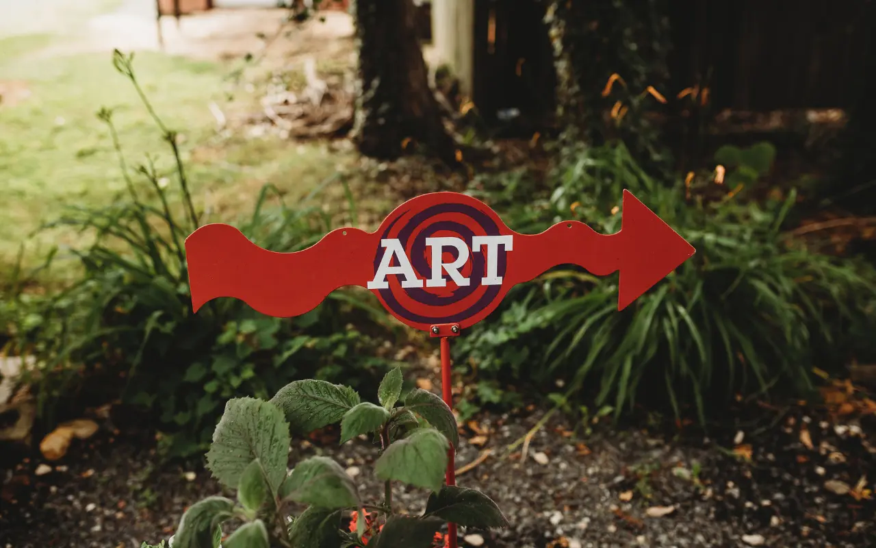 A red "Art" sign in the gardens of Chestertown