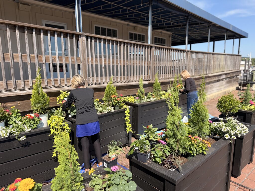 Thanks to the hands-on hard work of Bill and Kay MacIntosh, Ellen Hurst, and Patricia Pheiffer, the planters have been filled with beautiful greens and vibrant blooms, readying the waterfront for another wonderful season.